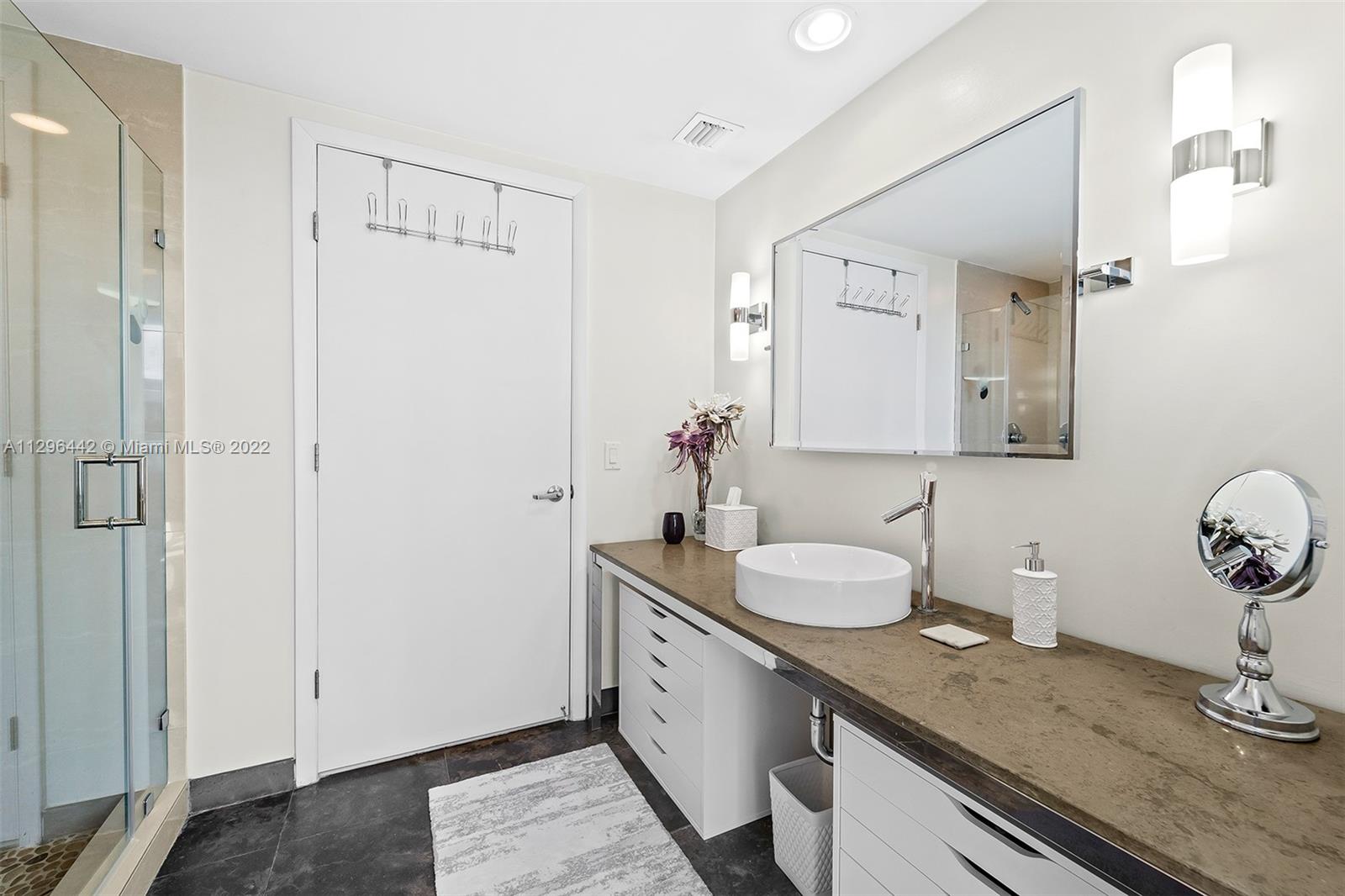 495 Brickell Avenue, Unit BAY405 Miami, FL 33131 - Photo 13 of 25 a bathroom with a granite countertop sink and a mirror