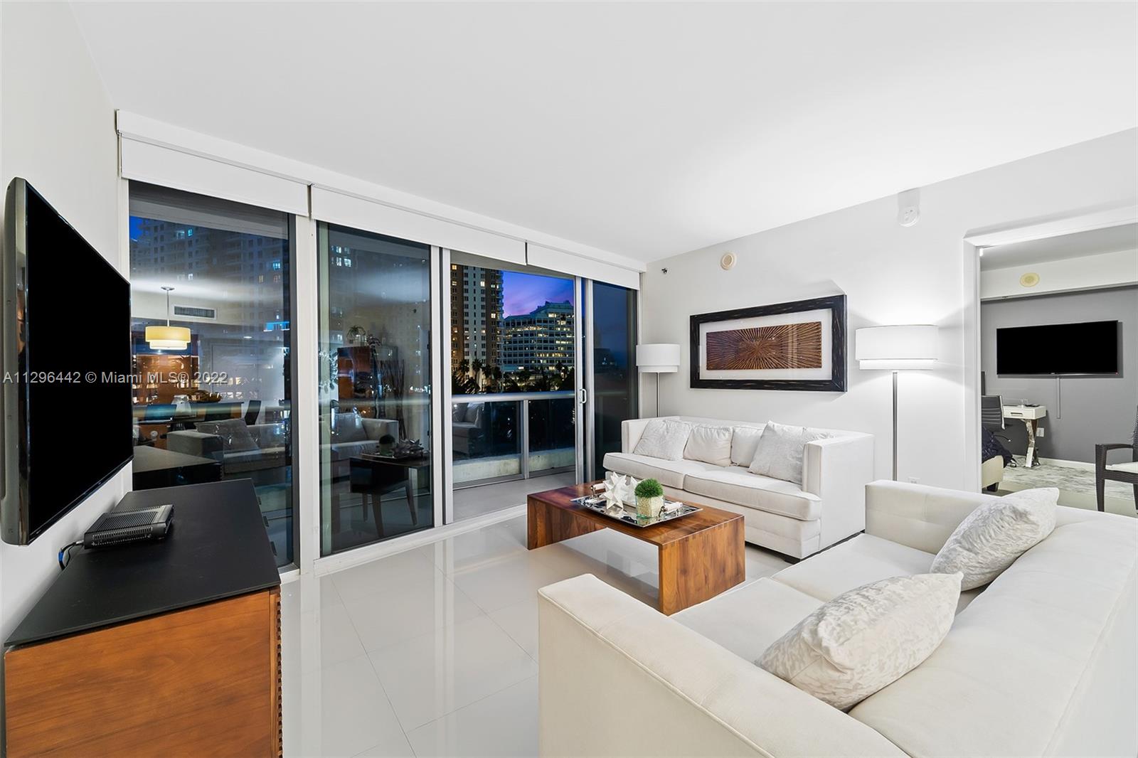 495 Brickell Avenue, Unit BAY405 Miami, FL 33131 - Photo 25 of 25 a living room with furniture and a flat screen tv