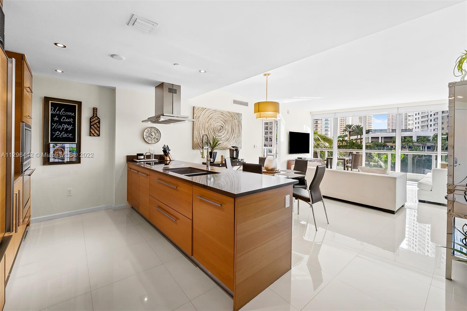 495 Brickell Avenue, Unit BAY405 Miami, FL 33131 - Photo 4 of 25 a kitchen with stainless steel appliances kitchen island granite countertop a sink and cabinets