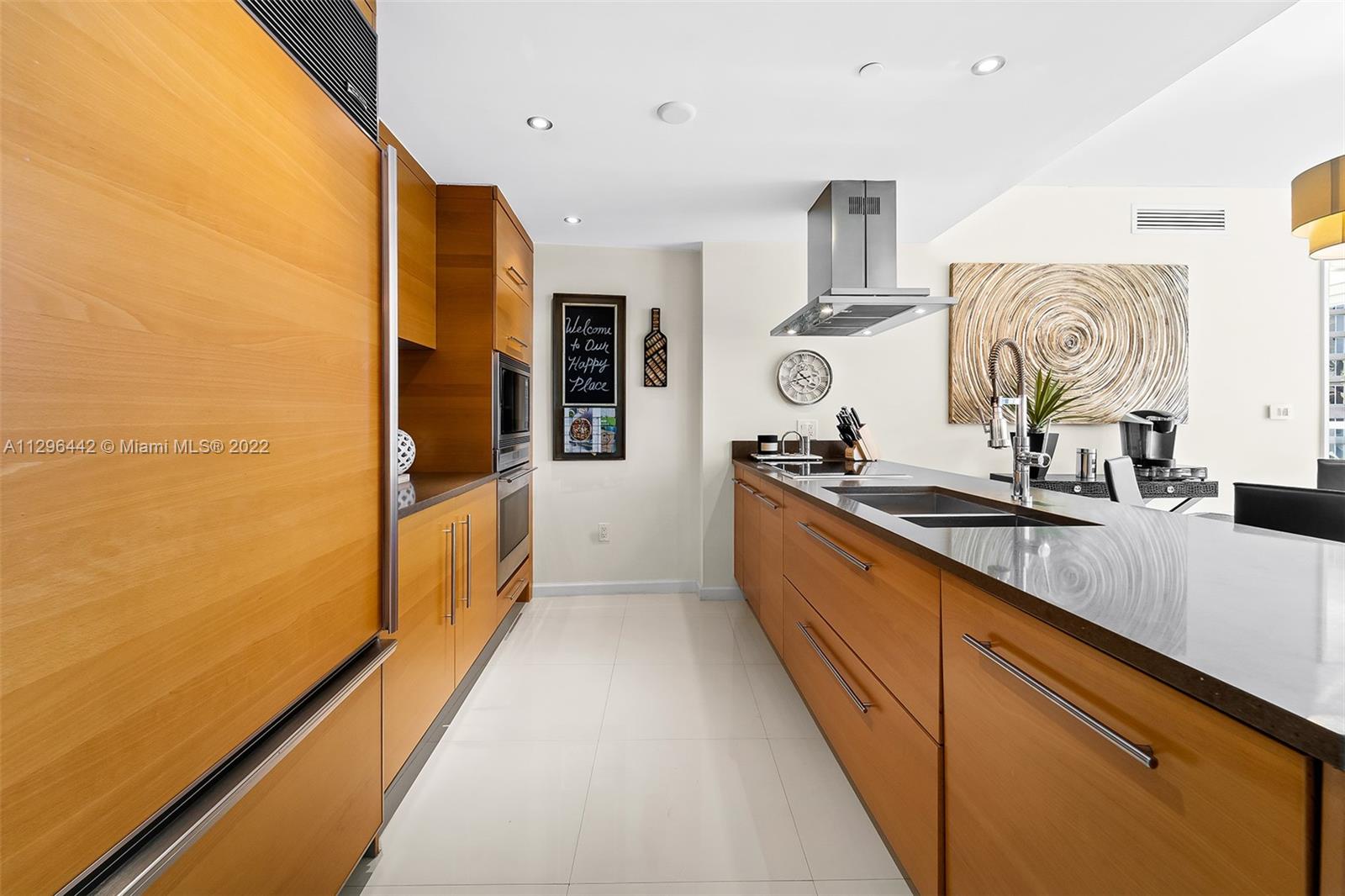 495 Brickell Avenue, Unit BAY405 Miami, FL 33131 - Photo 5 of 25 a large kitchen with stainless steel appliances a sink and cabinets