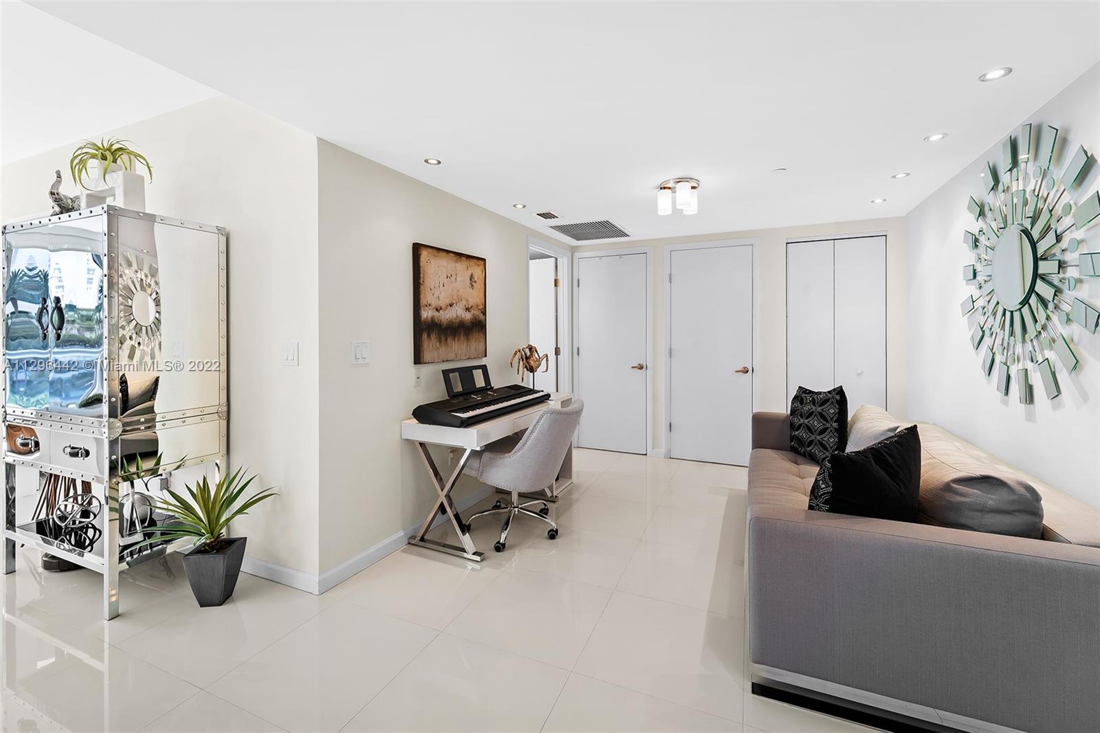 495 Brickell Avenue, Unit BAY405 Miami, FL 33131 - Photo 7 of 25 a living room with furniture a potted plant and a potted plant