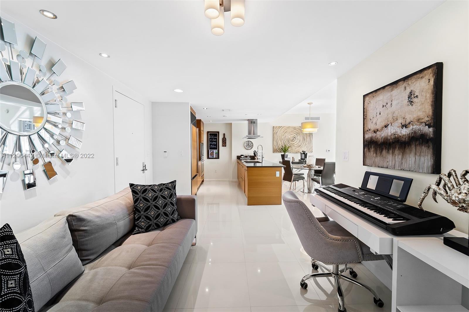 495 Brickell Avenue, Unit BAY405 Miami, FL 33131 - Photo 8 of 25 a living room with furniture and a flat screen tv