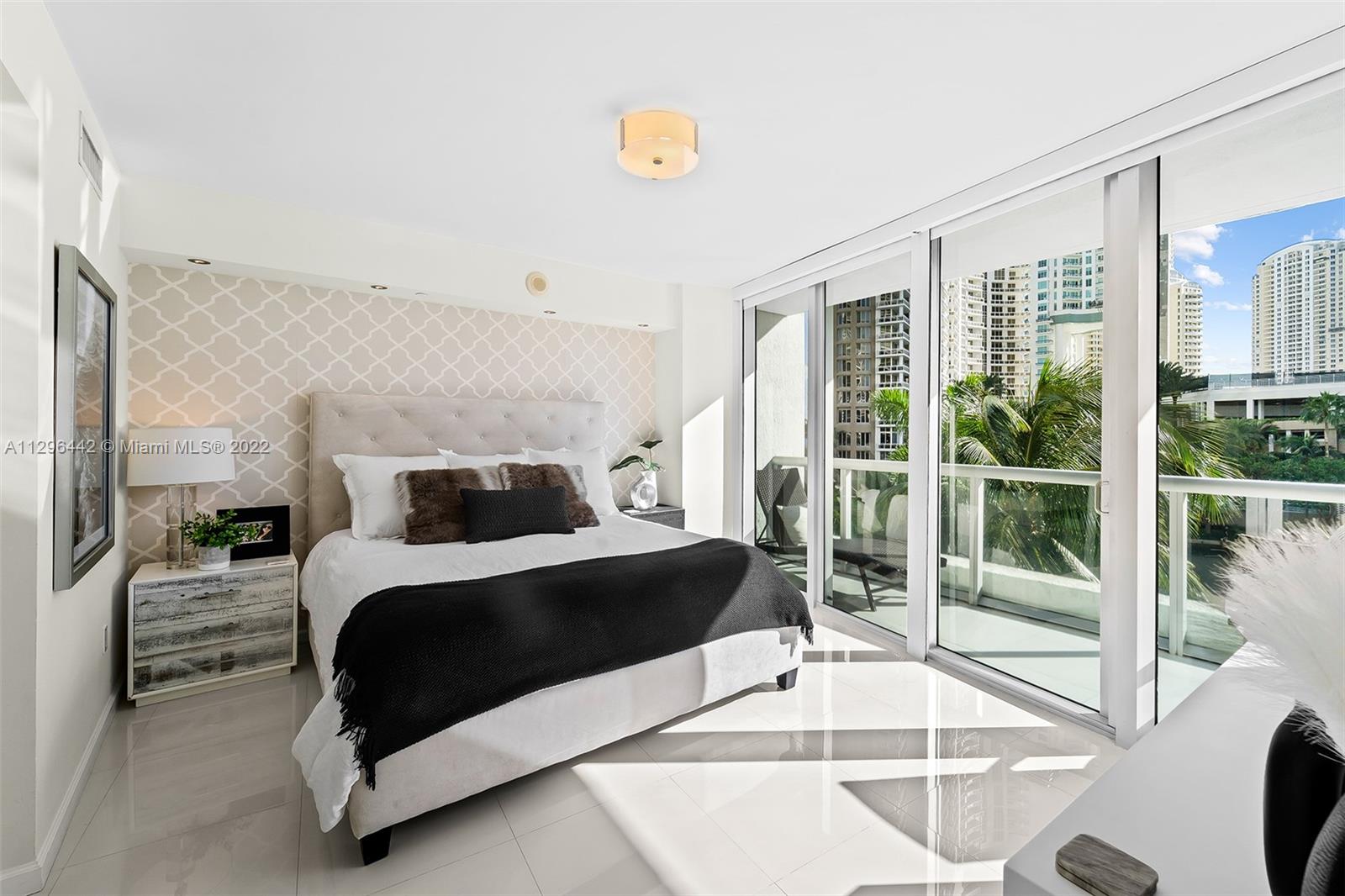 495 Brickell Avenue, Unit BAY405 Miami, FL 33131 - Photo 9 of 25 a bedroom with a large bed and a large window