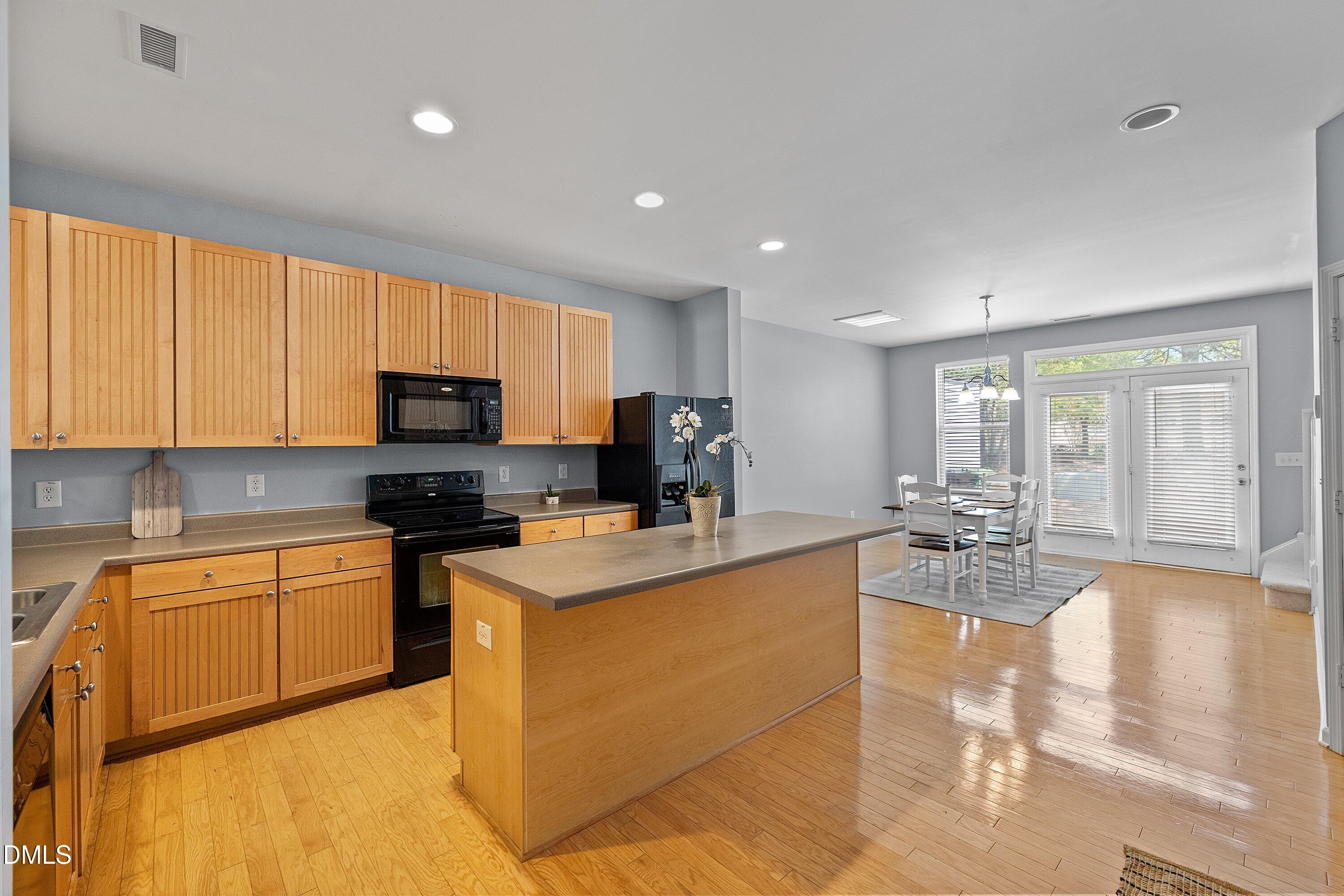 3114 Rapid Falls Road Cary, NC 27519 - Photo 12 of 37 a kitchen with stainless steel appliances granite countertop a sink a stove and cabinets