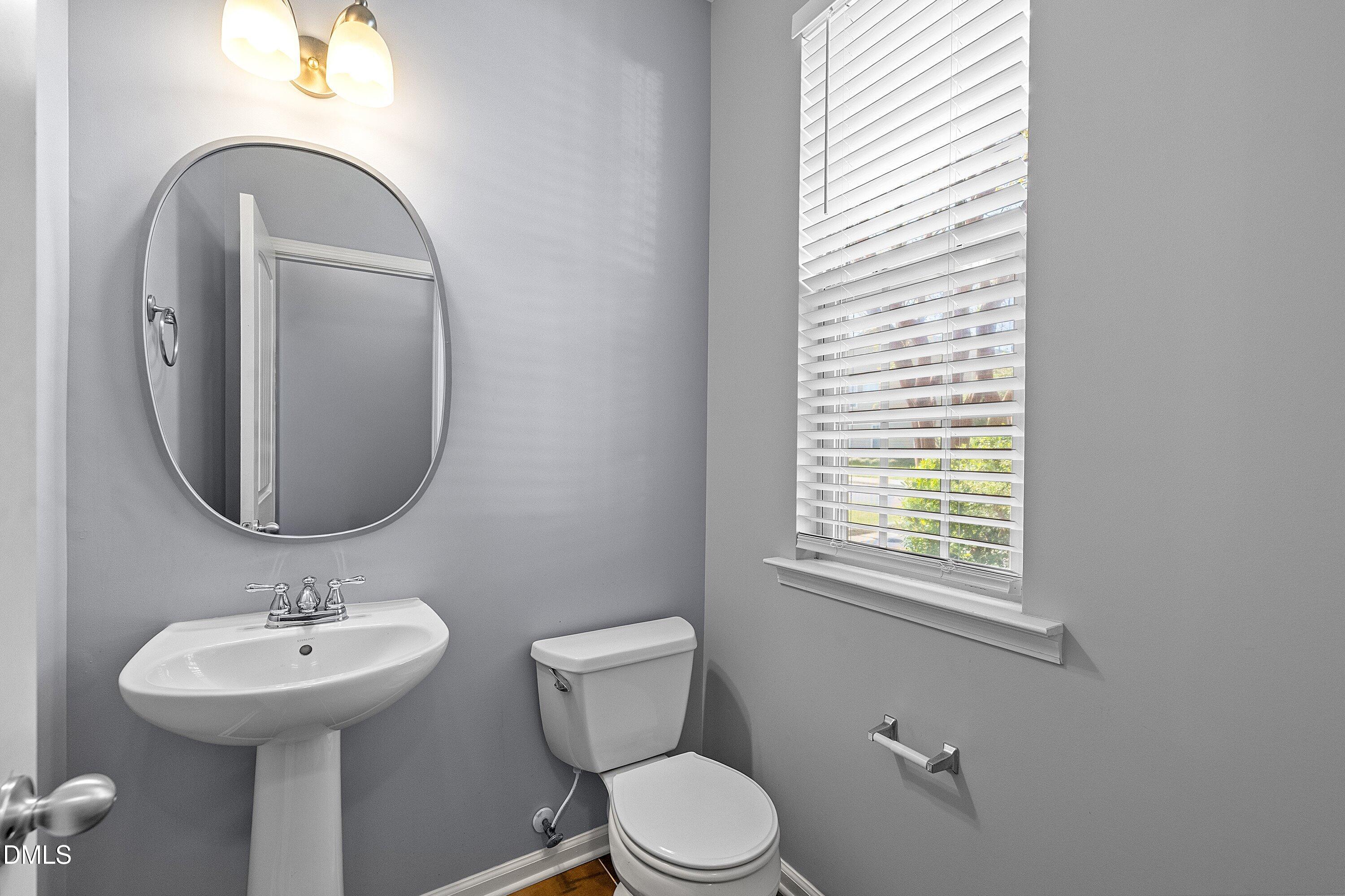 3114 Rapid Falls Road Cary, NC 27519 - Photo 26 of 37 a bathroom with a toilet sink and mirror