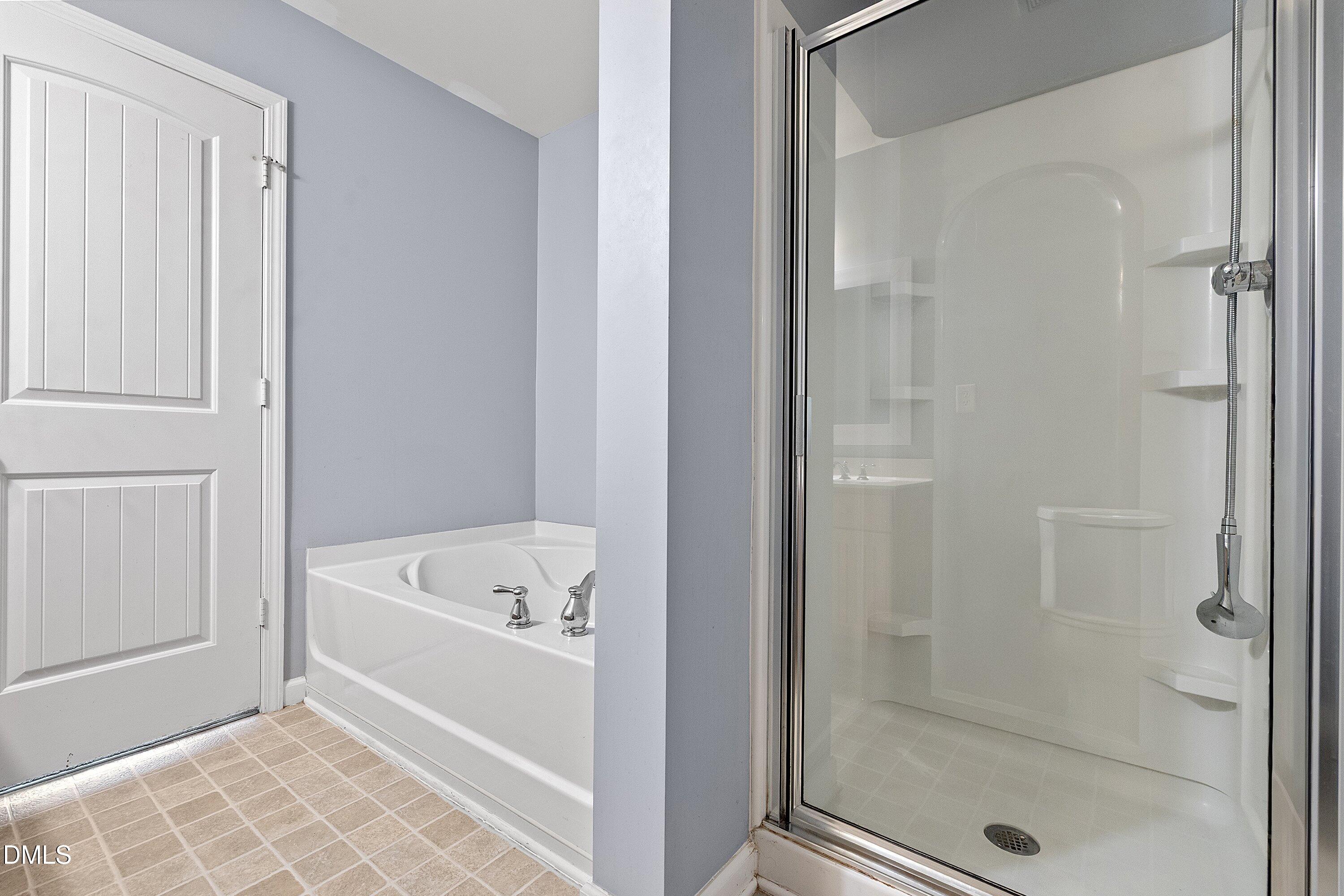 3114 Rapid Falls Road Cary, NC 27519 - Photo 28 of 37 a bathroom with a bathtub and shower