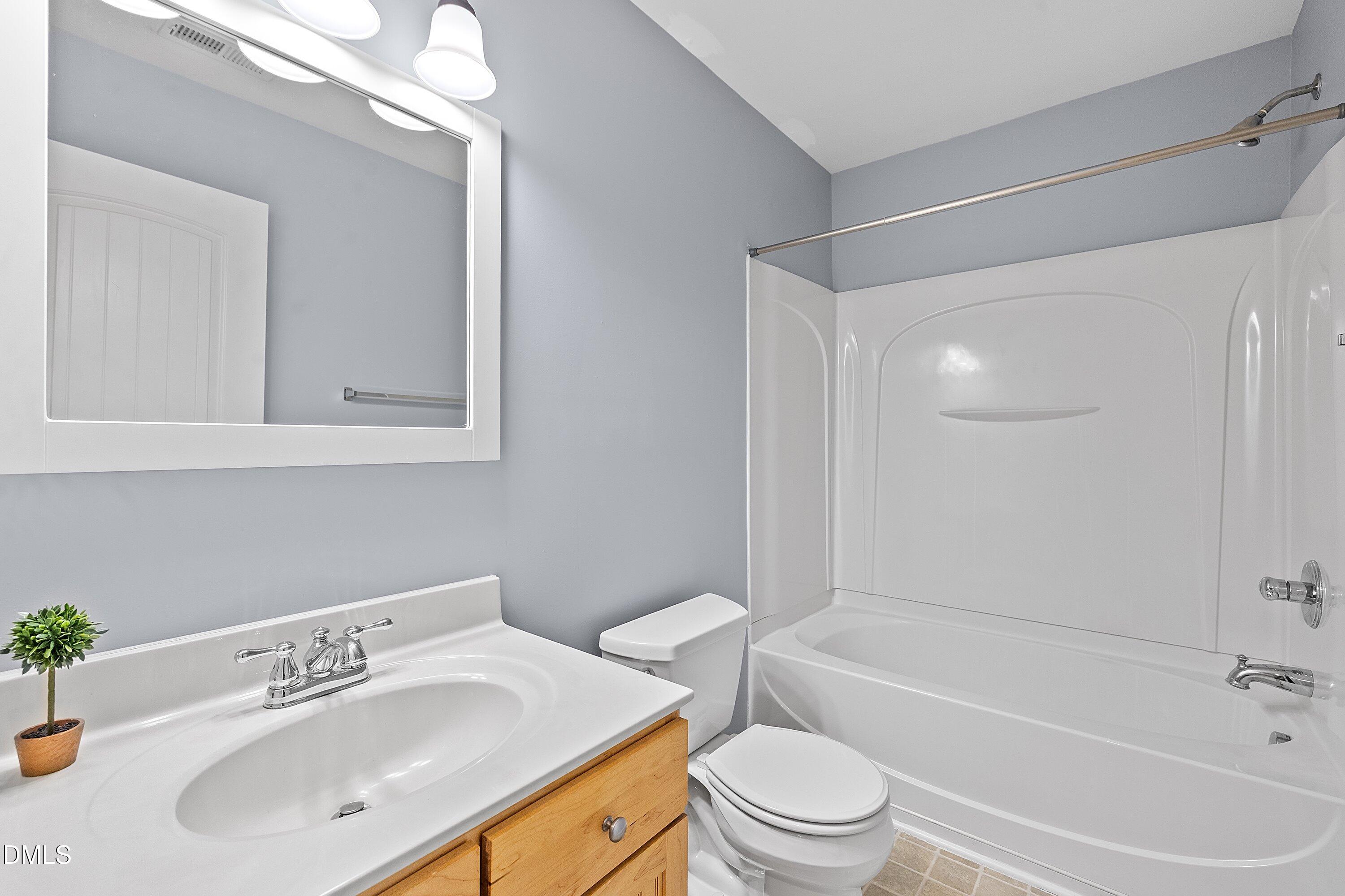 3114 Rapid Falls Road Cary, NC 27519 - Photo 29 of 37 a bathroom with a sink mirror toilet and bathtub