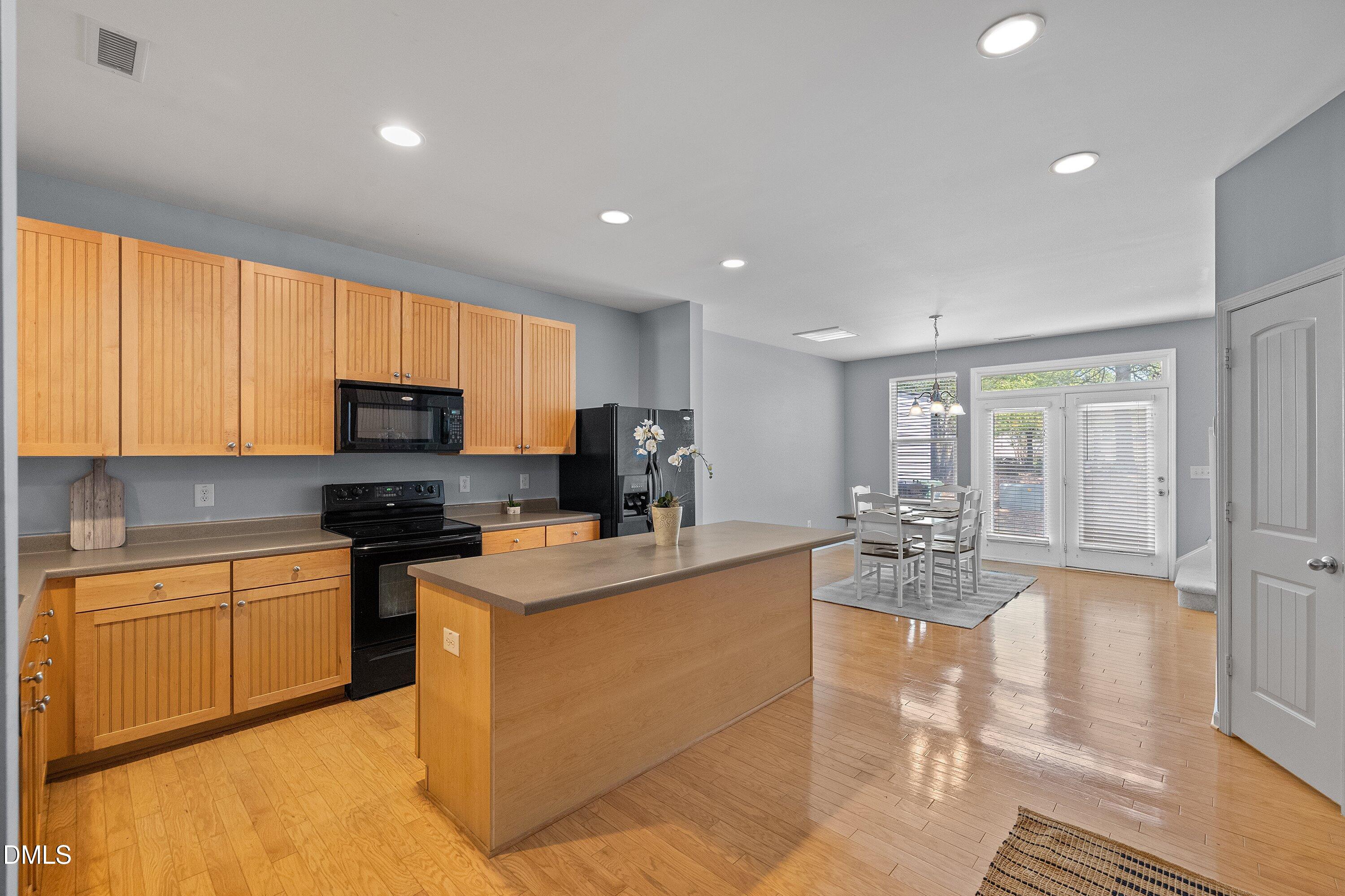 3114 Rapid Falls Road Cary, NC 27519 - Photo 6 of 37 a kitchen with stainless steel appliances granite countertop a sink a stove top oven a counter space and cabinets