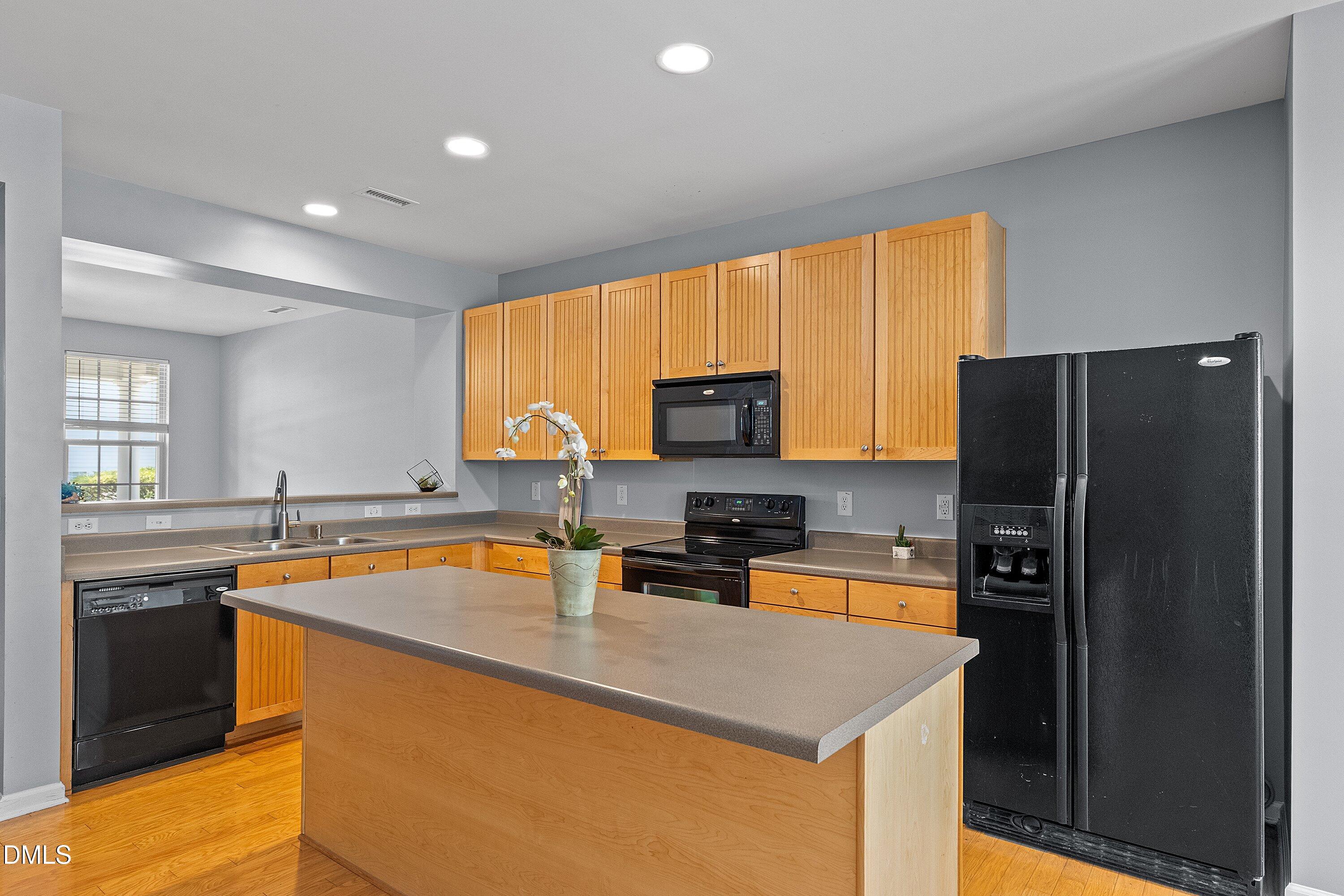 3114 Rapid Falls Road Cary, NC 27519 - Photo 8 of 37 a kitchen with stainless steel appliances granite countertop a sink a stove and refrigerator