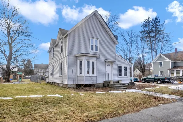 a view of a house with a yard covered with snow
