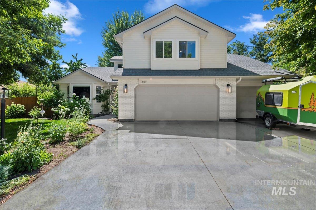 3411 North Summercrest Way Meridian, ID 83646 - Photo 2 of 30 View of front facade with brick siding, concrete driveway, an attached garage, and roof with shingles