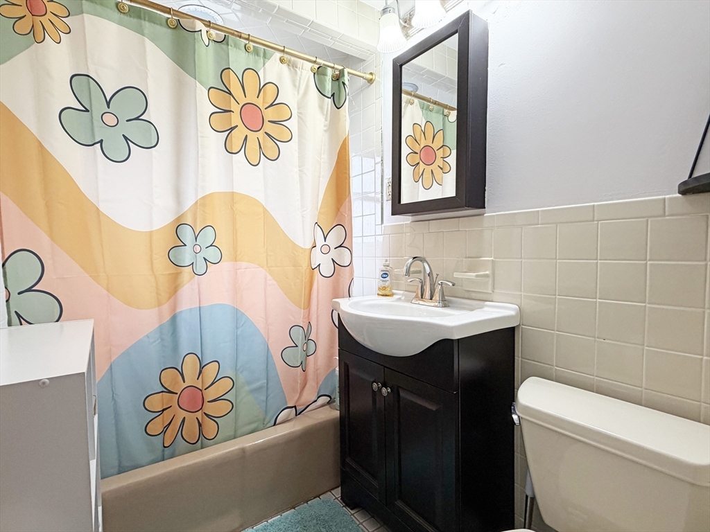 75-77 Dale Street, Unit 77 Waltham, MA 02451 - Photo 12 of 17 a bathroom with a sink and a mirror