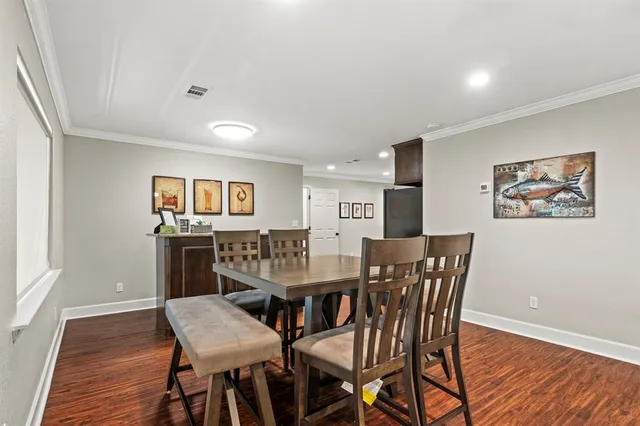 a view of a dining room with furniture and wooden floor
