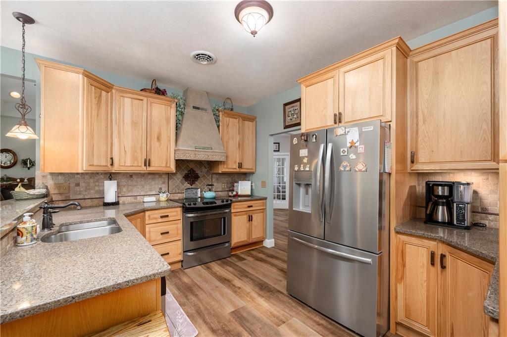 825 Whitestown Road Butler, PA 16001 - Photo 15 of 49 a kitchen with stainless steel appliances granite countertop a refrigerator stove and sink
