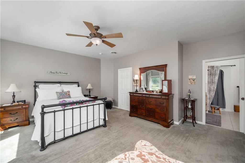 825 Whitestown Road Butler, PA 16001 - Photo 22 of 49 a bedroom with a bed and a chandelier