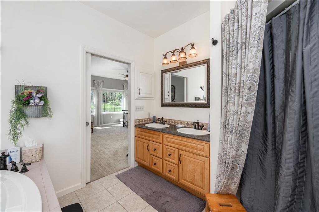 825 Whitestown Road Butler, PA 16001 - Photo 23 of 49 a bathroom with a sink a mirror and a shower
