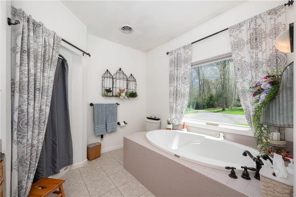 825 Whitestown Road Butler, PA 16001 - Photo 24 of 49 a white bath tub sitting next to a bathroom