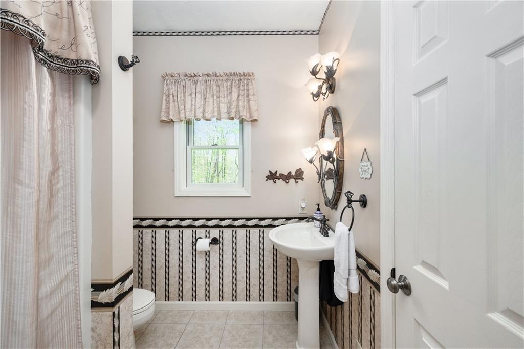 825 Whitestown Road Butler, PA 16001 - Photo 28 of 49 a bathroom with a sink a mirror and a window