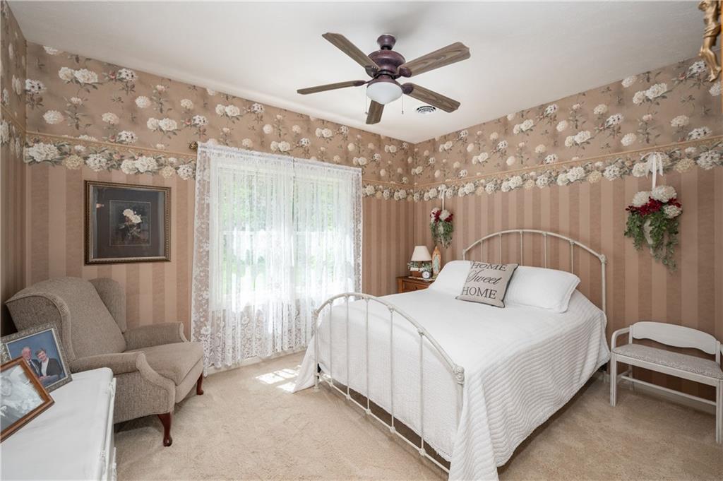825 Whitestown Road Butler, PA 16001 - Photo 29 of 49 a bedroom with a bed and a chandelier
