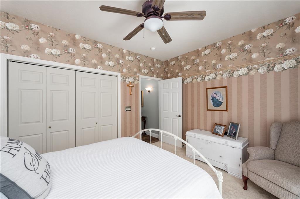 825 Whitestown Road Butler, PA 16001 - Photo 30 of 49 a spacious bedroom with a bed and a chandelier