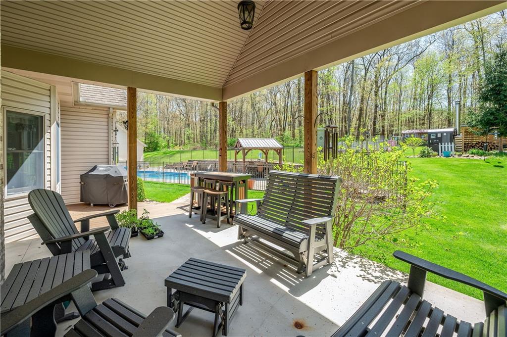 825 Whitestown Road Butler, PA 16001 - Photo 38 of 49 a view of a patio with table and chairs and couches with wooden floor and fence