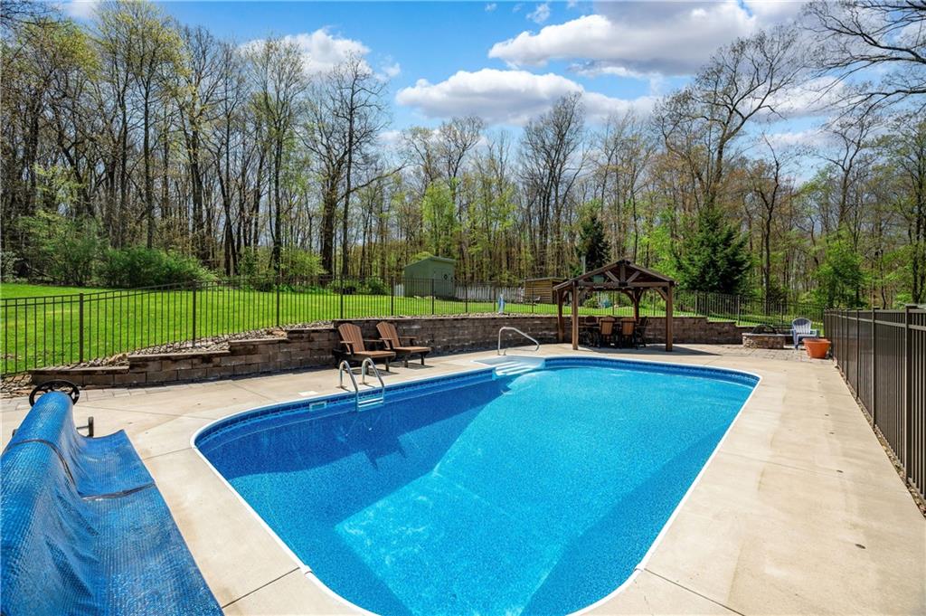 825 Whitestown Road Butler, PA 16001 - Photo 42 of 49 a view of swimming pool with chairs and trees in the background