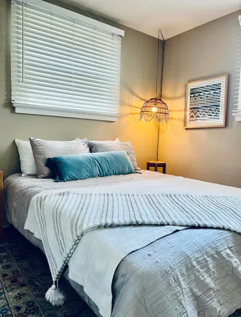 a bedroom with a bed and a painting on the wall