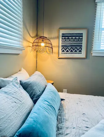 a bedroom with a bed and a painting on the wall