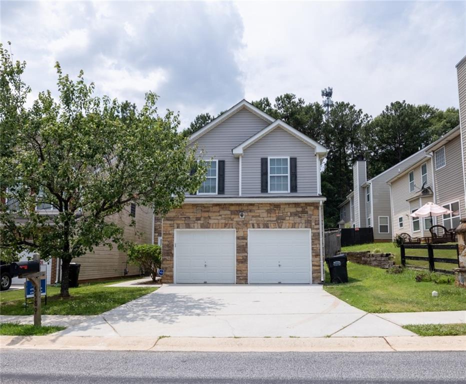 a front view of house with yard and green space