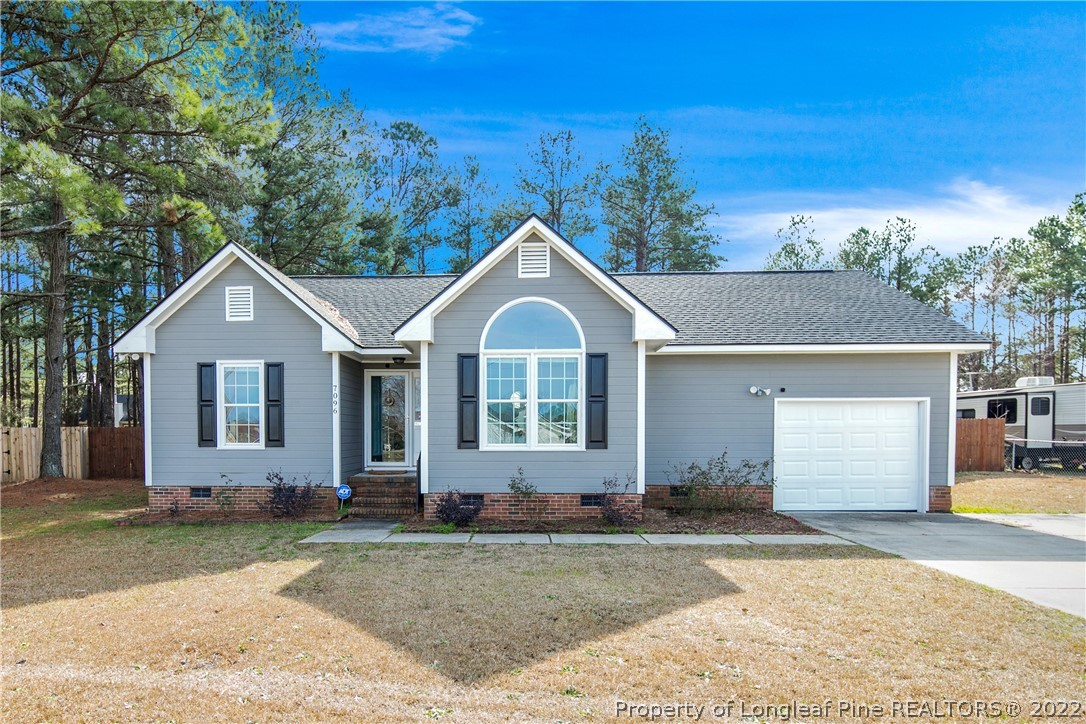 7096 Rockfish Road Raeford, NC 28376 - Photo 1 of 40 a front view of a house with a yard and garage