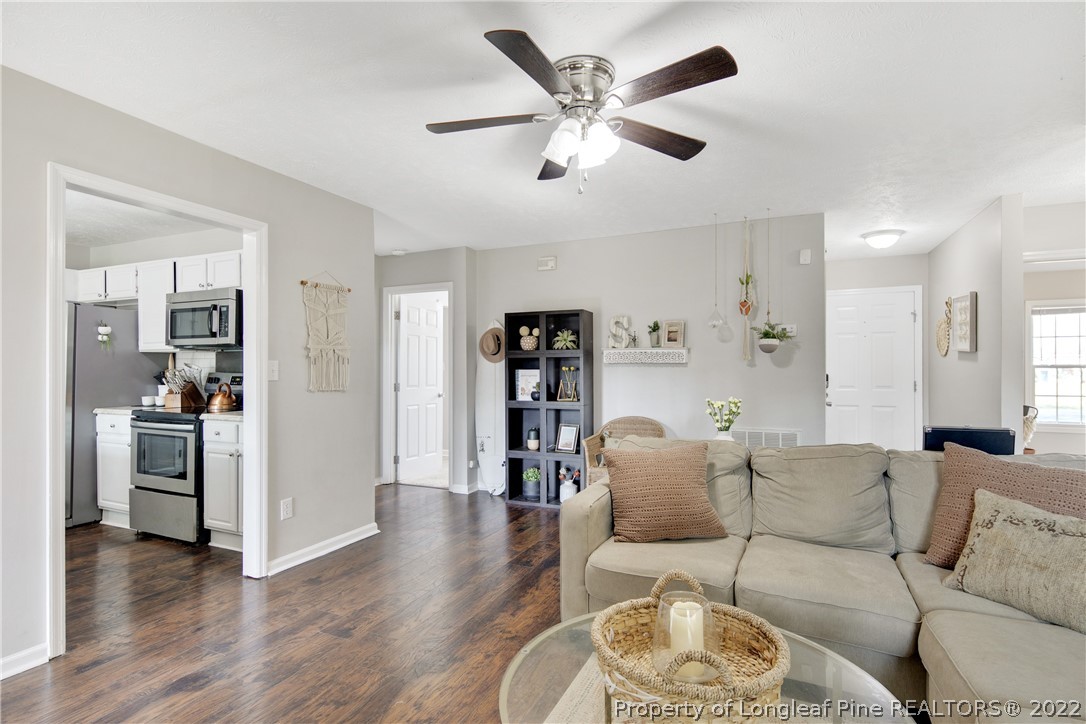 7096 Rockfish Road Raeford, NC 28376 - Photo 11 of 40 a living room with furniture and wooden floor
