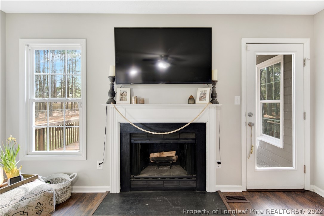 7096 Rockfish Road Raeford, NC 28376 - Photo 12 of 40 a living room with furniture and a fireplace