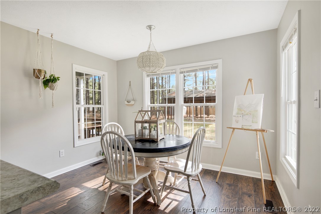7096 Rockfish Road Raeford, NC 28376 - Photo 17 of 40 a dining room with furniture window wooden floor