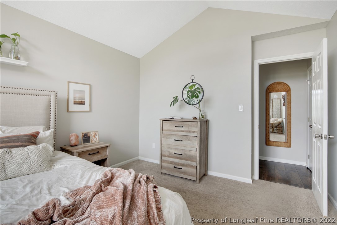7096 Rockfish Road Raeford, NC 28376 - Photo 25 of 40 a bedroom with a bed and ceiling fan