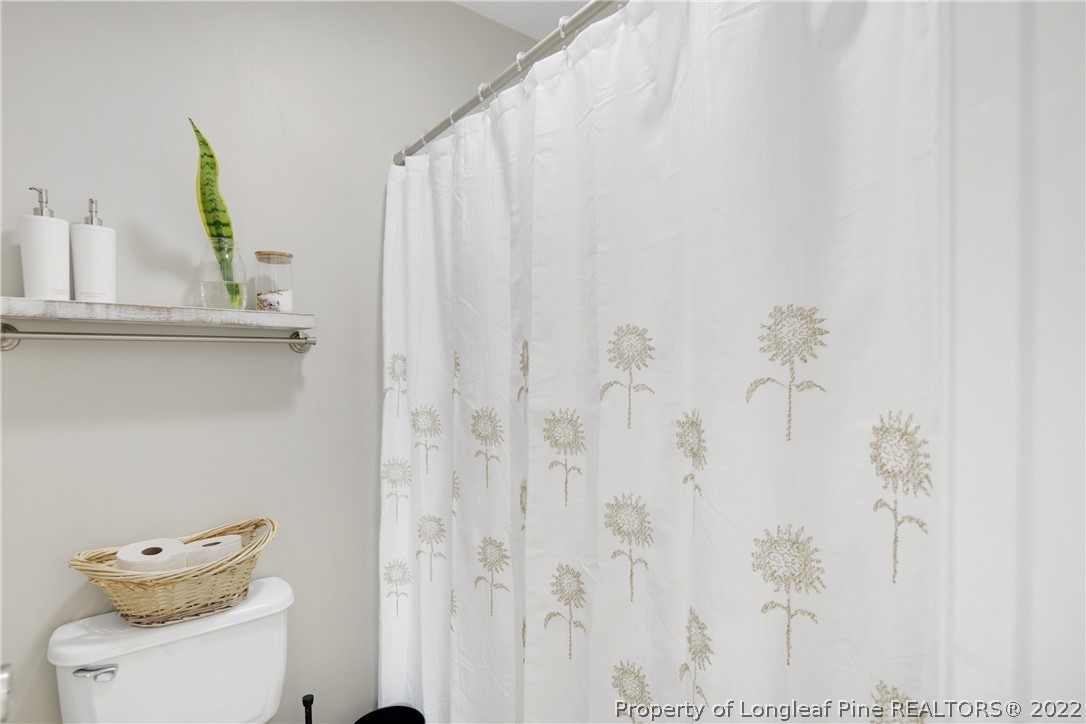 7096 Rockfish Road Raeford, NC 28376 - Photo 28 of 40 a bathroom with a toilet and a sink