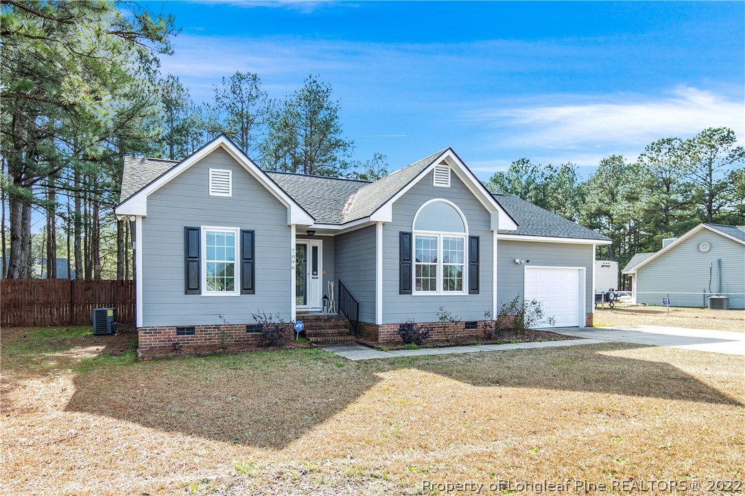 7096 Rockfish Road Raeford, NC 28376 - Photo 3 of 40 a front view of a house with a yard