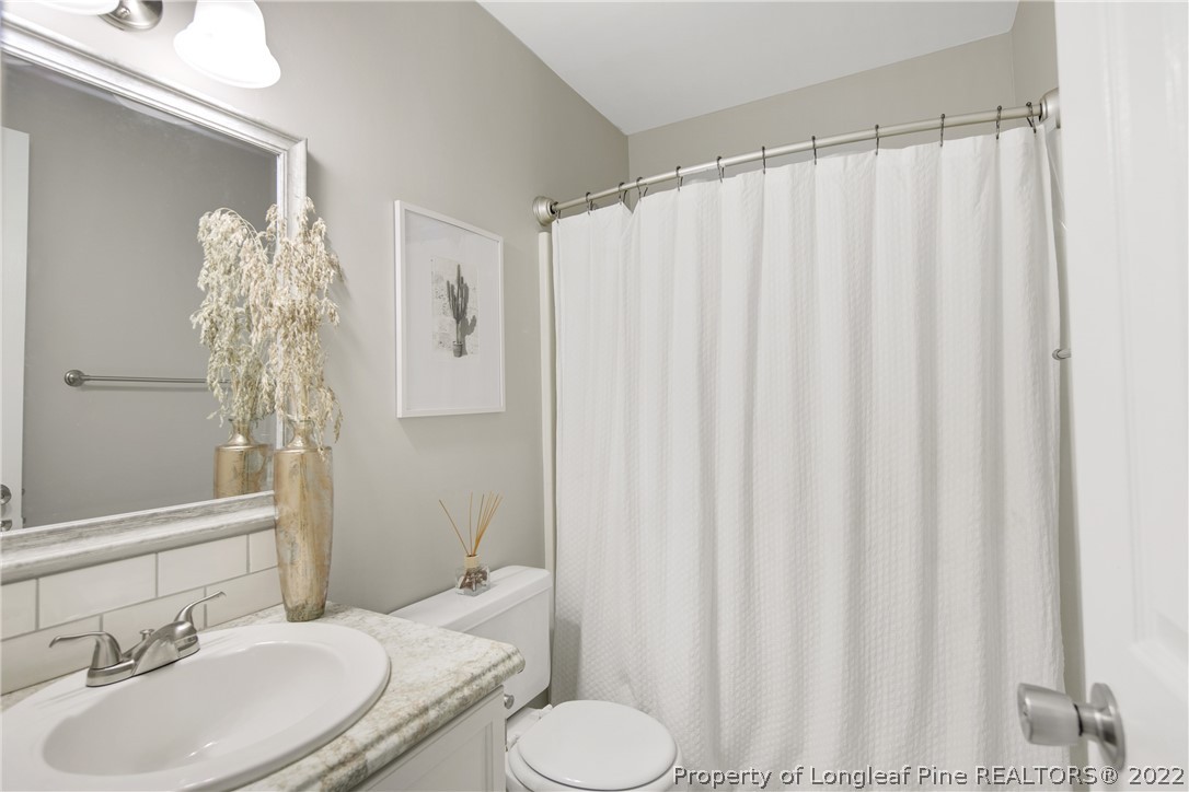 7096 Rockfish Road Raeford, NC 28376 - Photo 34 of 40 a bathroom with a sink and toilet