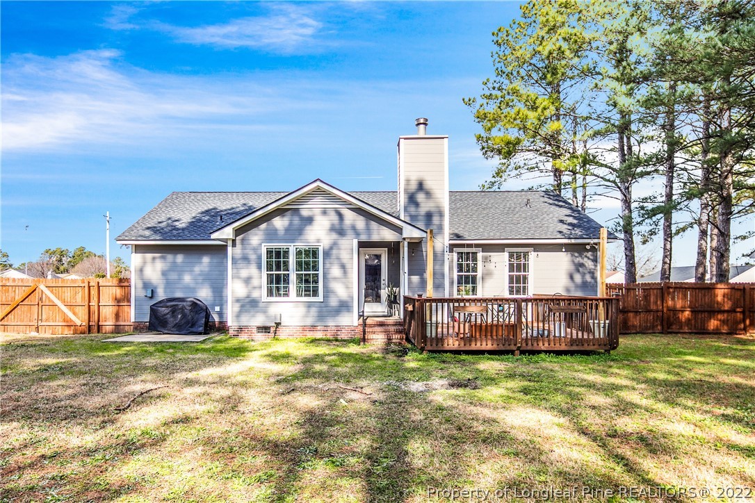 7096 Rockfish Road Raeford, NC 28376 - Photo 35 of 40 a front view of a house with a garden and tree