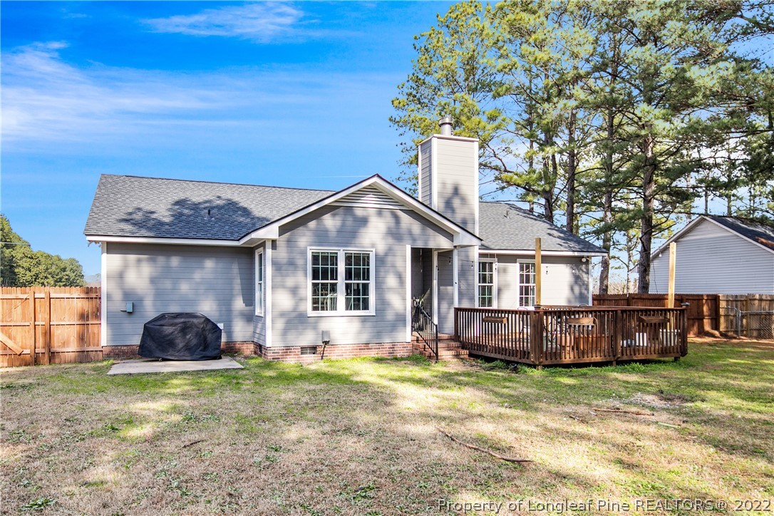 7096 Rockfish Road Raeford, NC 28376 - Photo 37 of 40 a front view of a house with a garden and yard