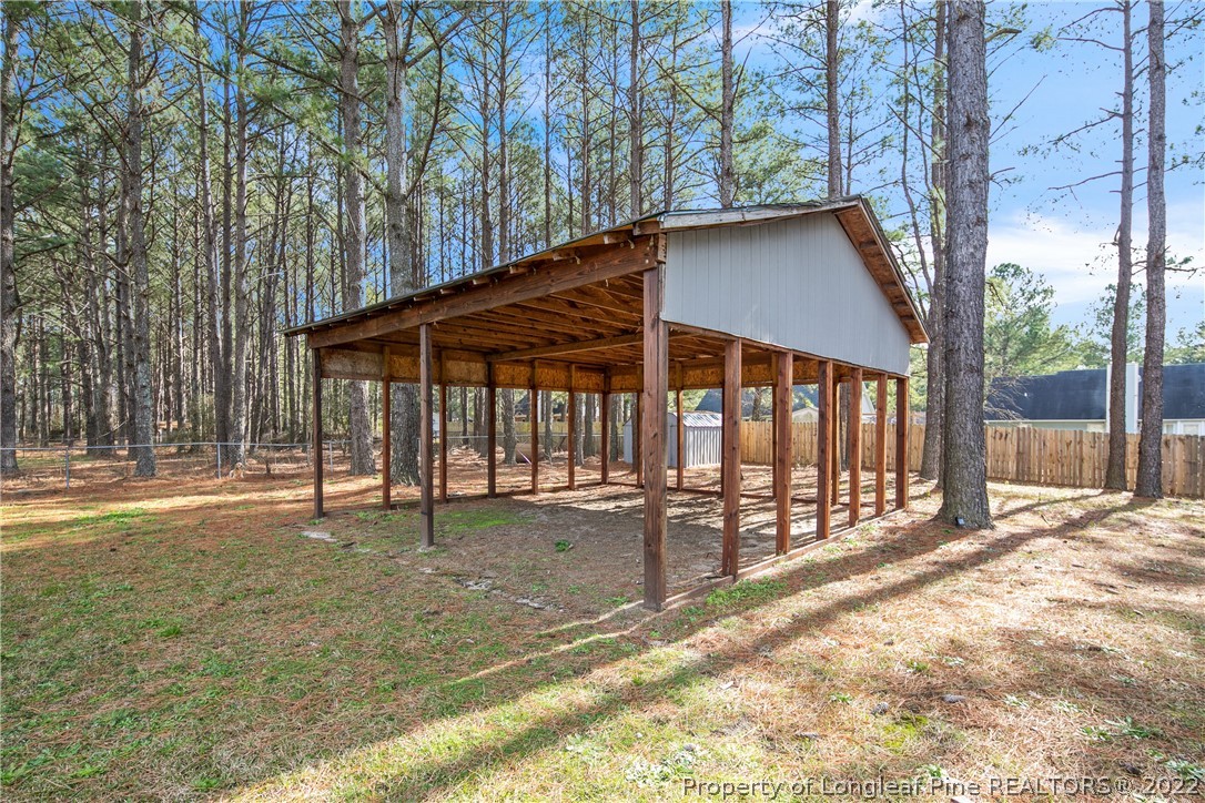 7096 Rockfish Road Raeford, NC 28376 - Photo 39 of 40 a view of a house with backyard and sitting area