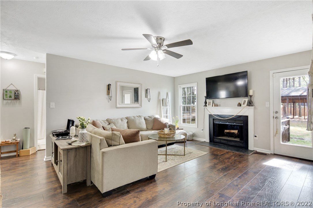 7096 Rockfish Road Raeford, NC 28376 - Photo 9 of 40 a living room with furniture fireplace and flat screen tv