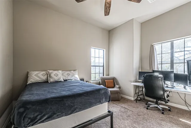 a bedroom with a large bed and a window