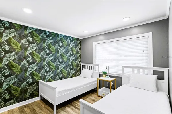 a bedroom with a bed and a flat screen tv