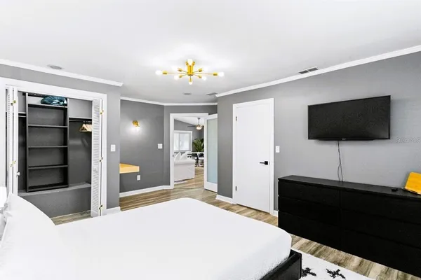 a living room with furniture dining area and a chandelier