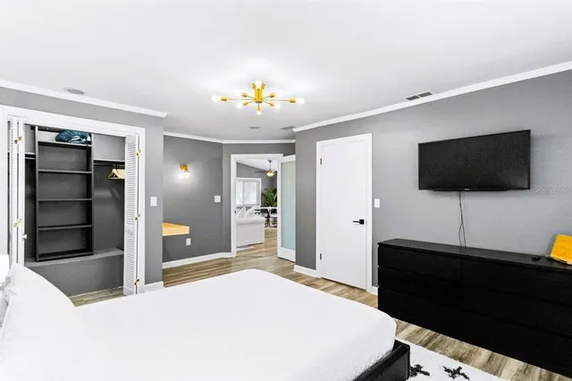 a living room with furniture dining area and a chandelier