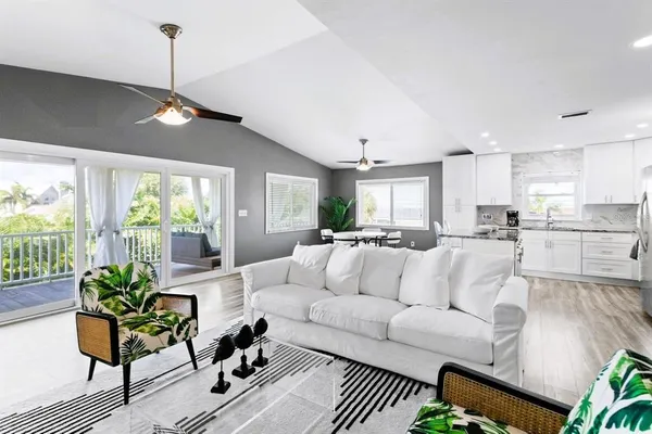 a living room with furniture dining table a window and appliances