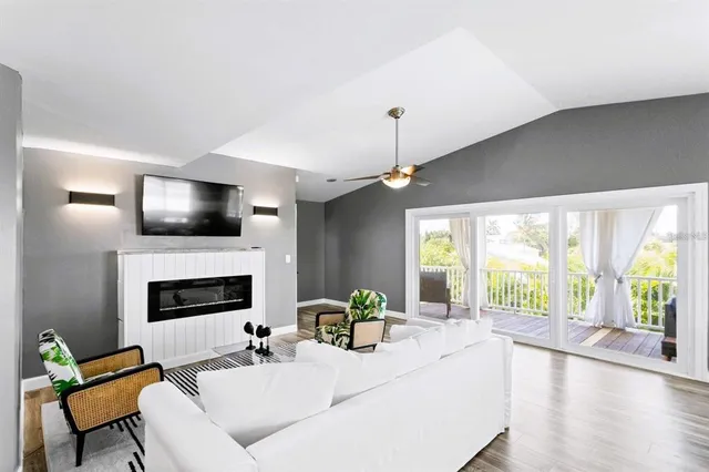 a large kitchen with cabinets a sink a stove and a chandelier