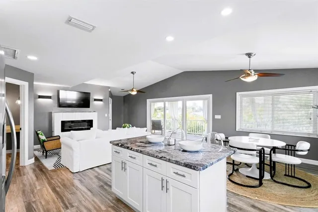 a kitchen with stainless steel appliances granite countertop a sink a stove and microwave