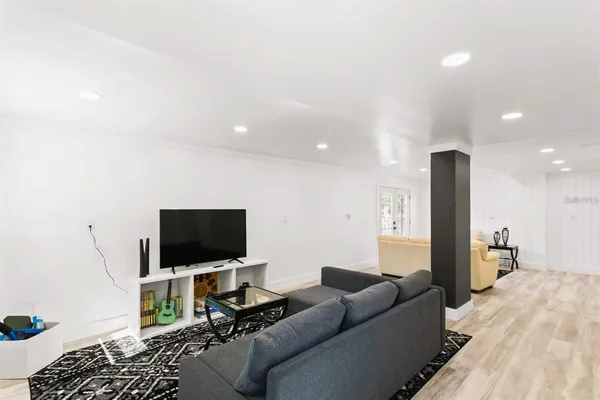 a living room with furniture and a wooden floor