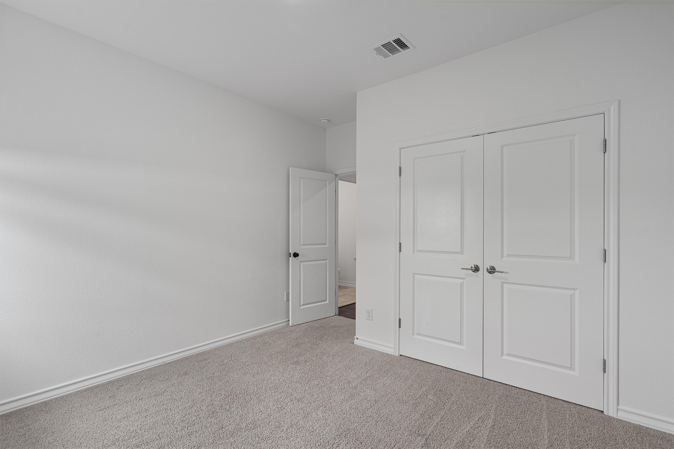 104 Stinchcomb Road Hutto, TX 78634 - Photo 28 of 40 Bedroom 4 is located down the hall near the center of the home, offering added flexibility and privacy. Positioned near the half bath, it would make a perfect home office, guest room, or flex space.